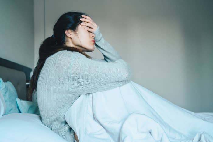 Woman feeling sick in bed