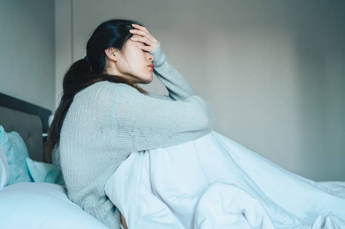 Woman feeling sick in bed