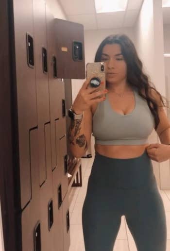 A reviewer wearing the sports bra top in grey 