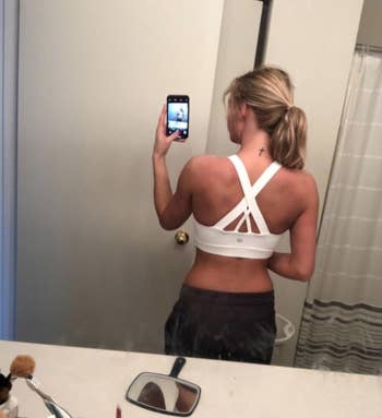 A reviewer wearing the sports bra in white 