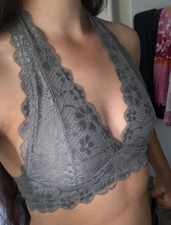 A reviewer wearing the bralette in grey 