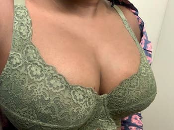 A reviewer wearing the bra in green 