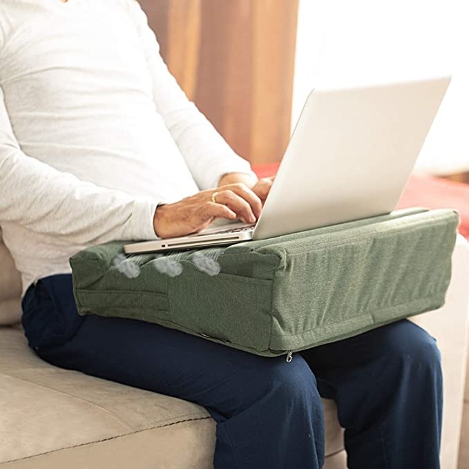 Man sitting with the laptop desk on his lap