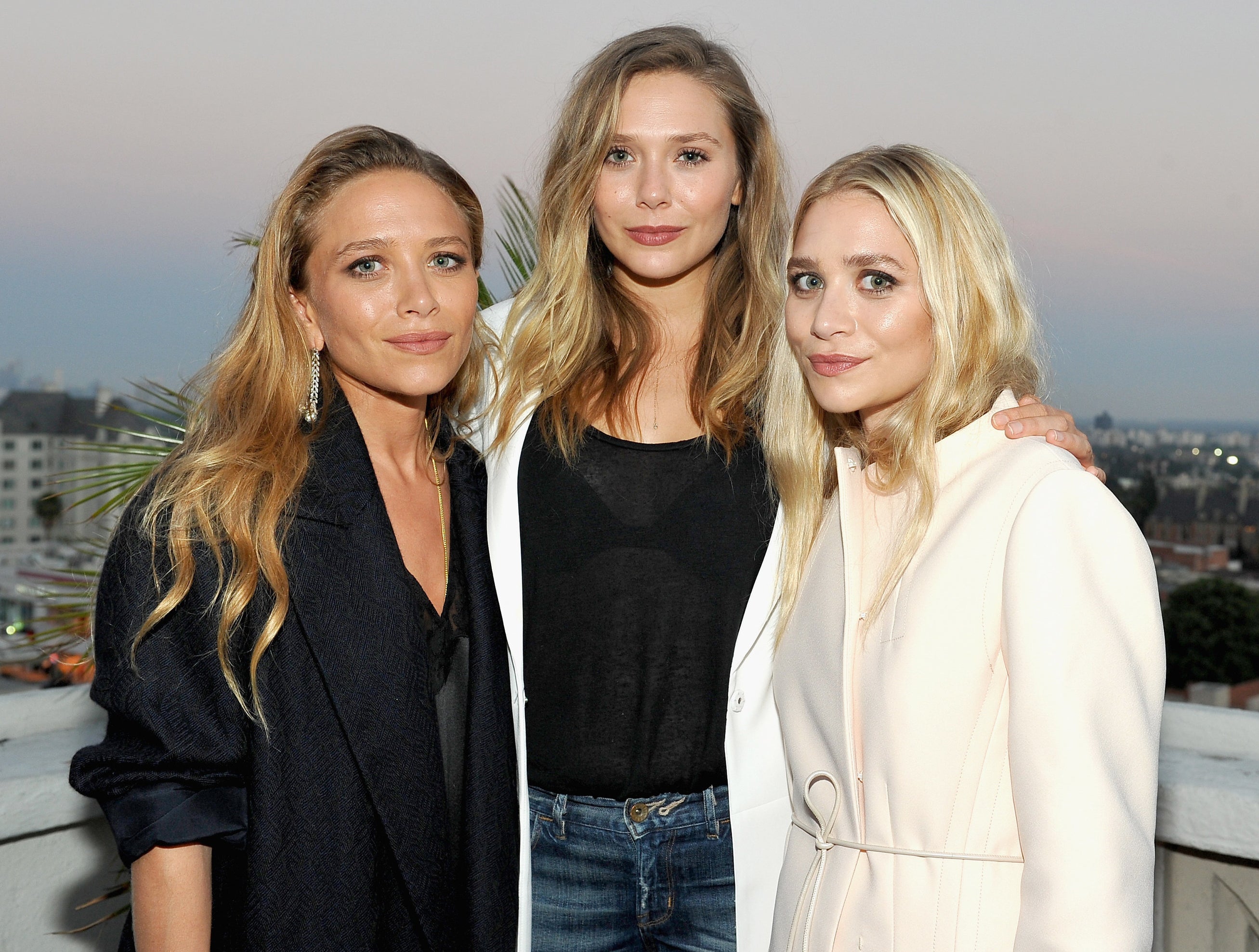Elizabeth poses with her sisters Mary Kate and Ashley recently