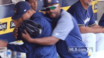 Baseball player hugging other player from behind