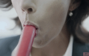 Woman licking a popsicle