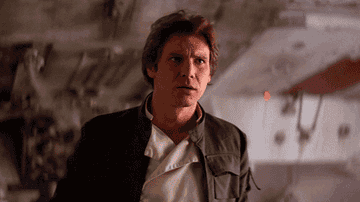 Harrison as Han Solo gesturing at himself