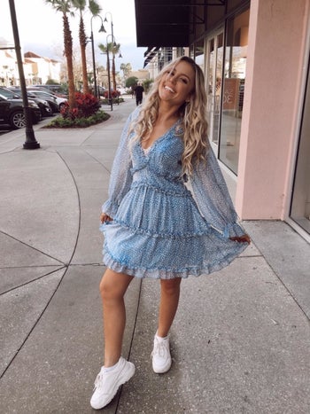 Reviewer wearing blue dress