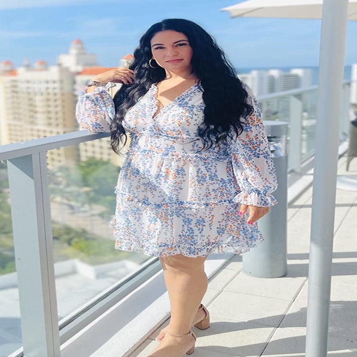 Reviewer wearing light blue dress