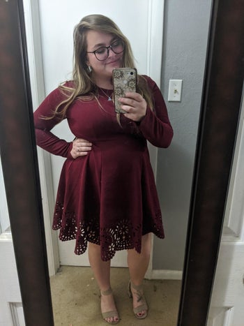 Reviewer wearing red dress with cutout hem