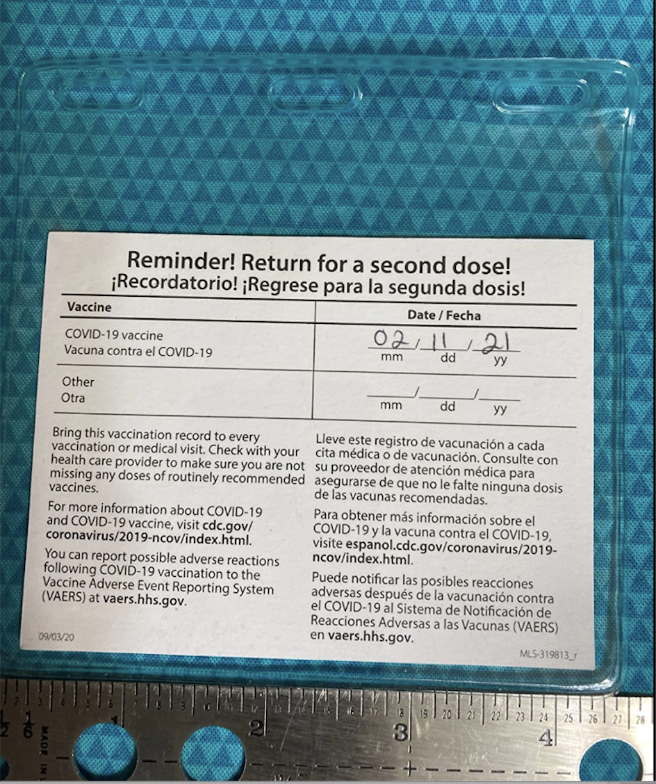 Back of a vaccine card in a vinyl sleeve 