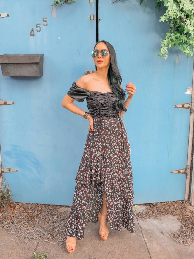 image of reviewer wearing the z-black pattern BTFBM boho floral high low skirt with a black ruched crop top
