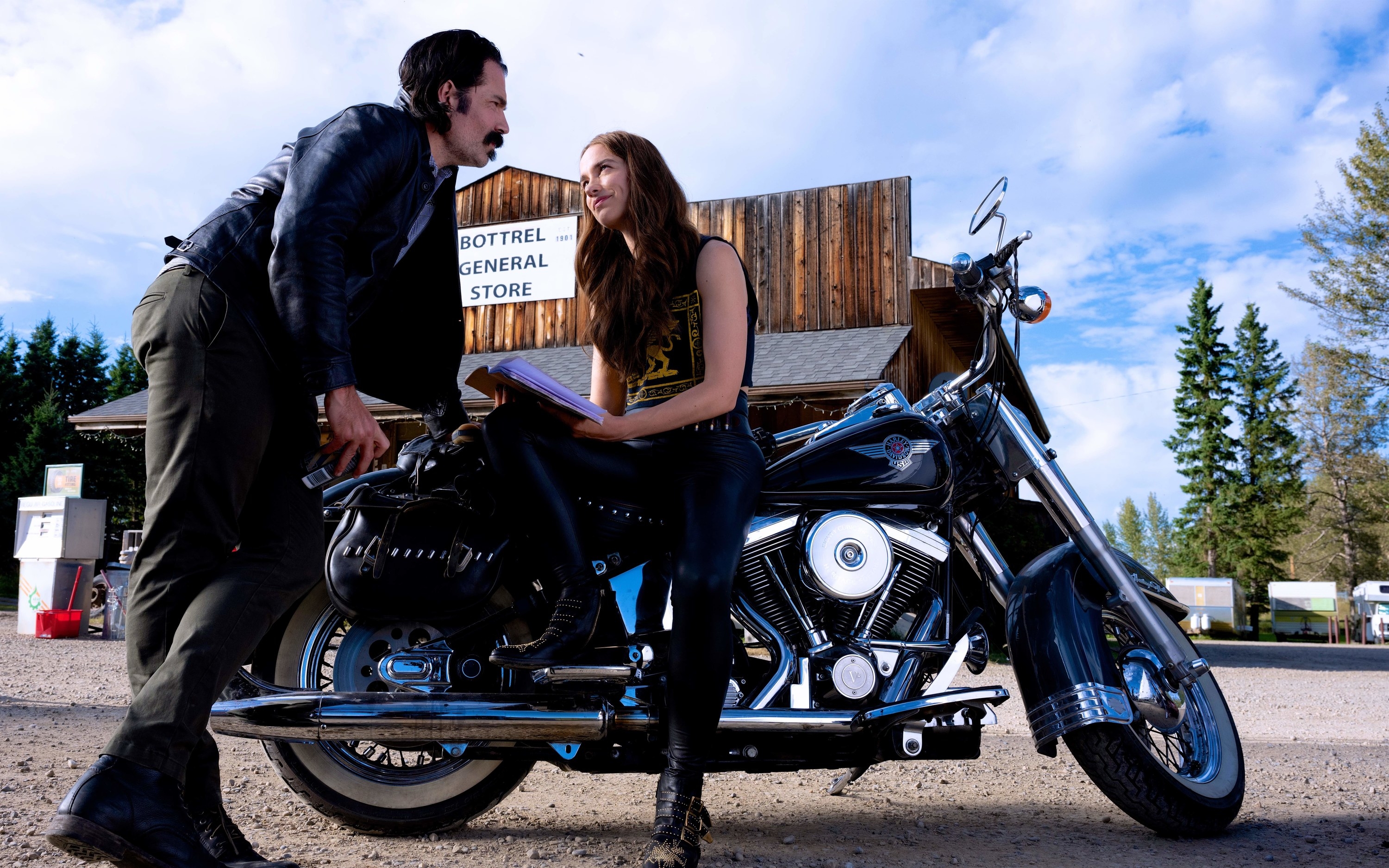 Doc and Wynonna talking while Wynonna sits on her motorcycle 