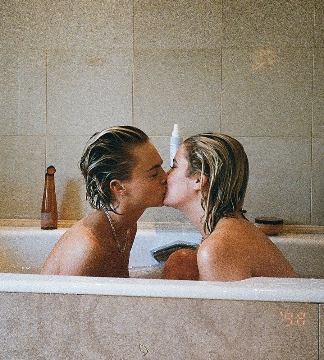 Cara and Ashley kissing together in a bathtub