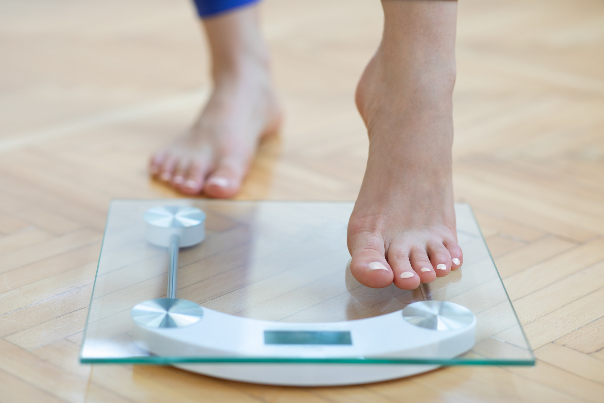 woman stepping on a scale