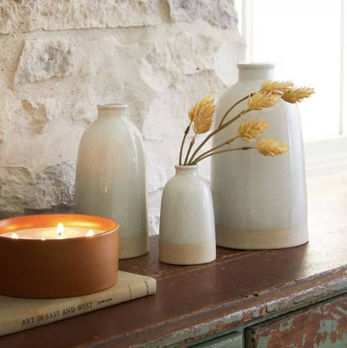 three ceramic stoneware vases on a ledge