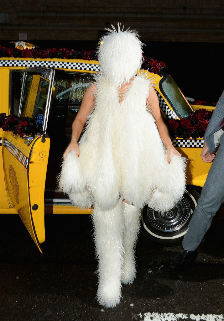 Gaga stepping out of a taxi in an all white furry outfit that covers her face