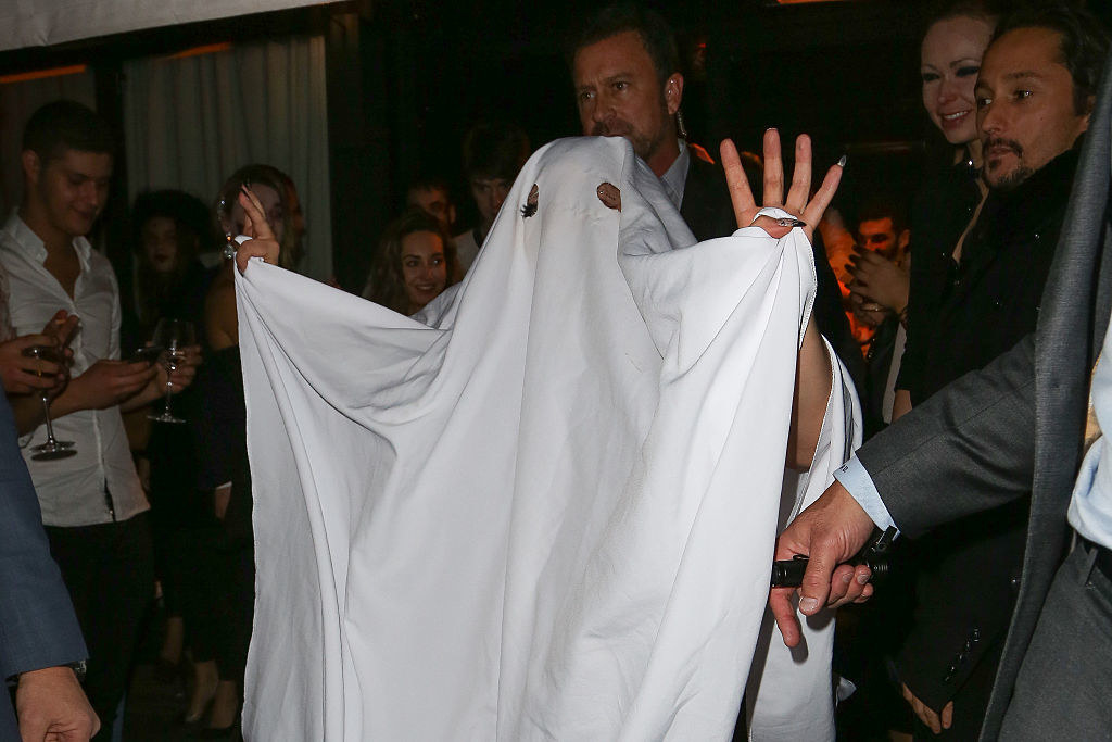 Gaga with a tablecloth over her and holes on her eyes