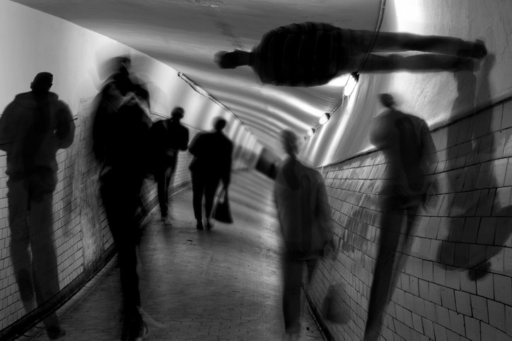 shadowy figures in a subway tunnel