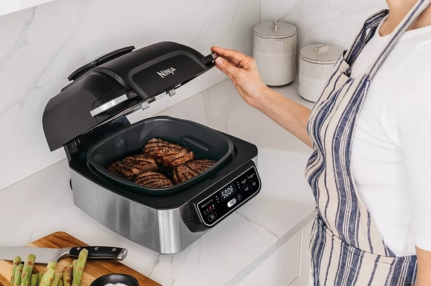 A model using the grill to make steak in a kitchen