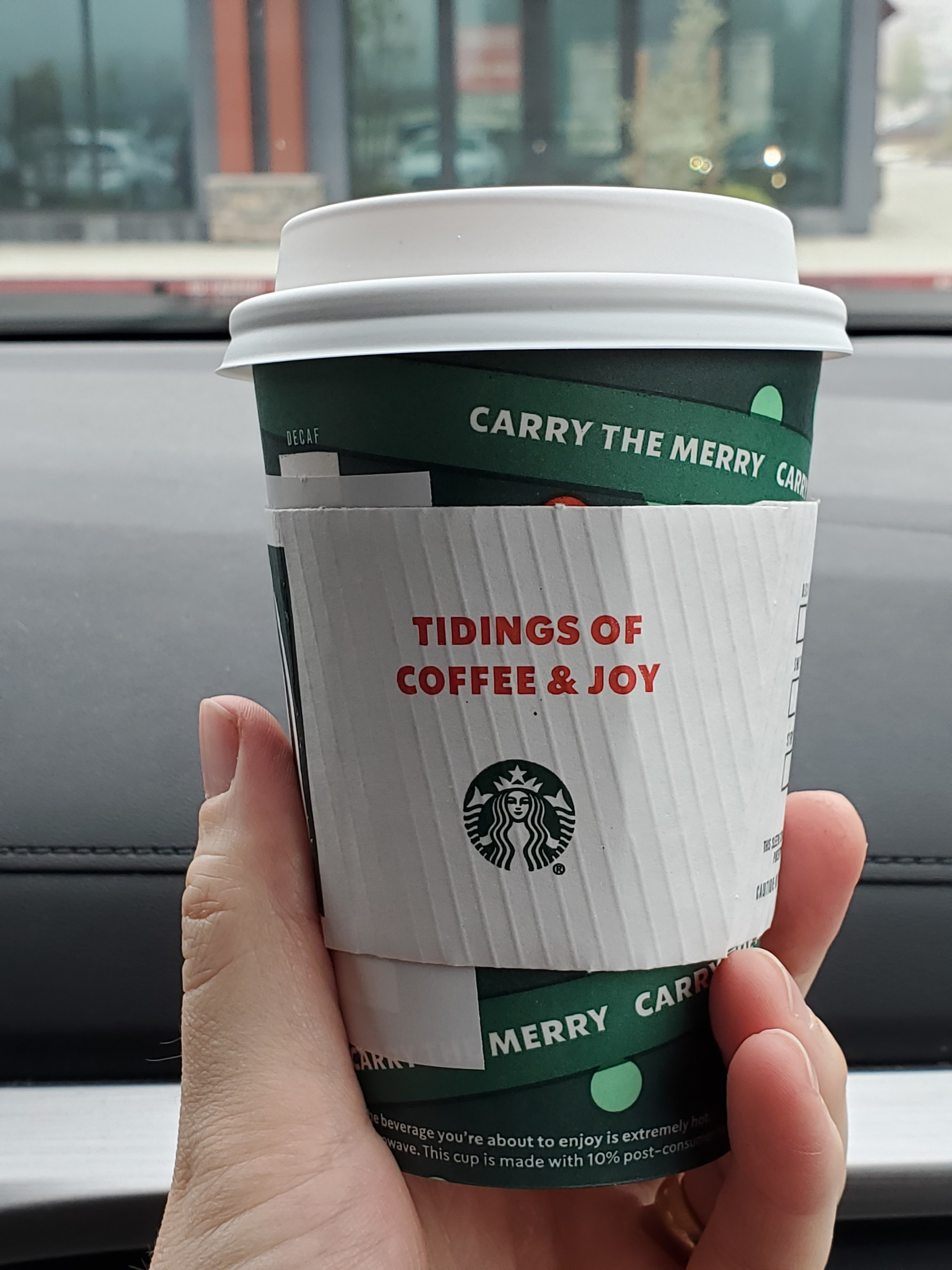 A Christmas-themed Starbucks cup