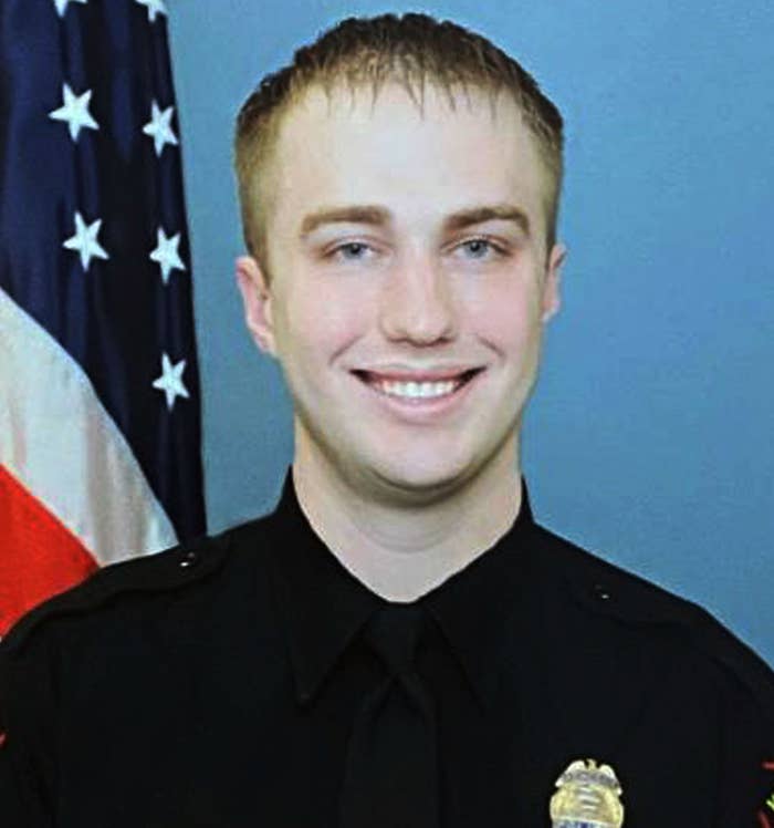 Kenosha Police Officer Rusten Sheskey smiles in front of the US flag while wearing his uniform