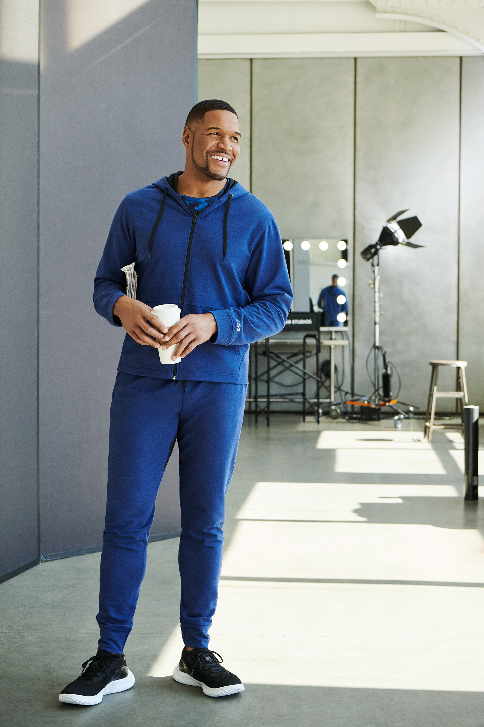 Michael Strahan wearing a matching zip-up hoodie and joggers
