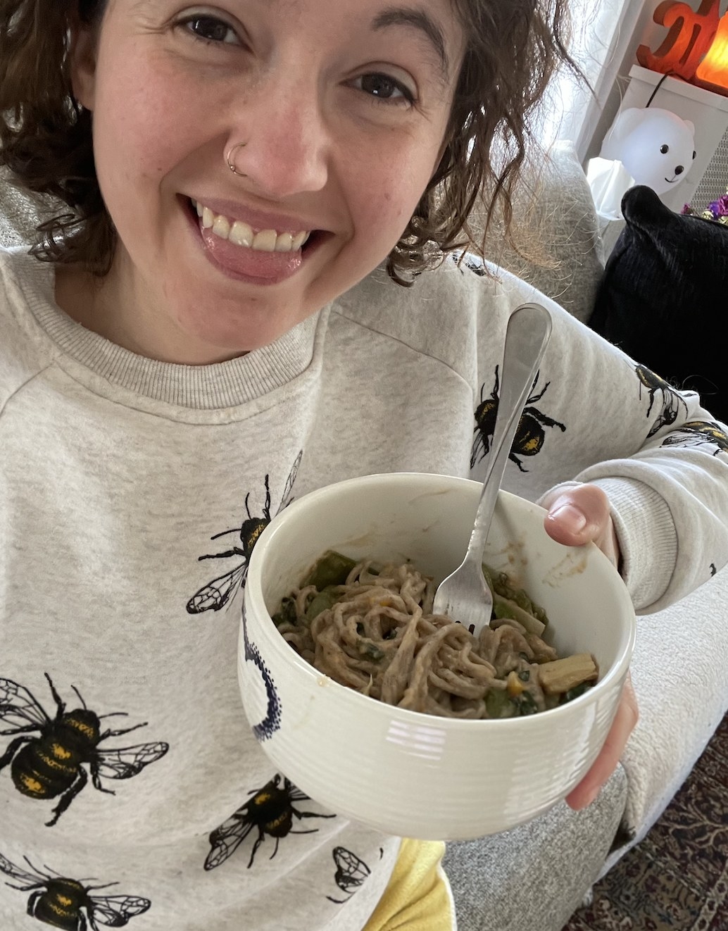 A person holding ginger sesame noodles