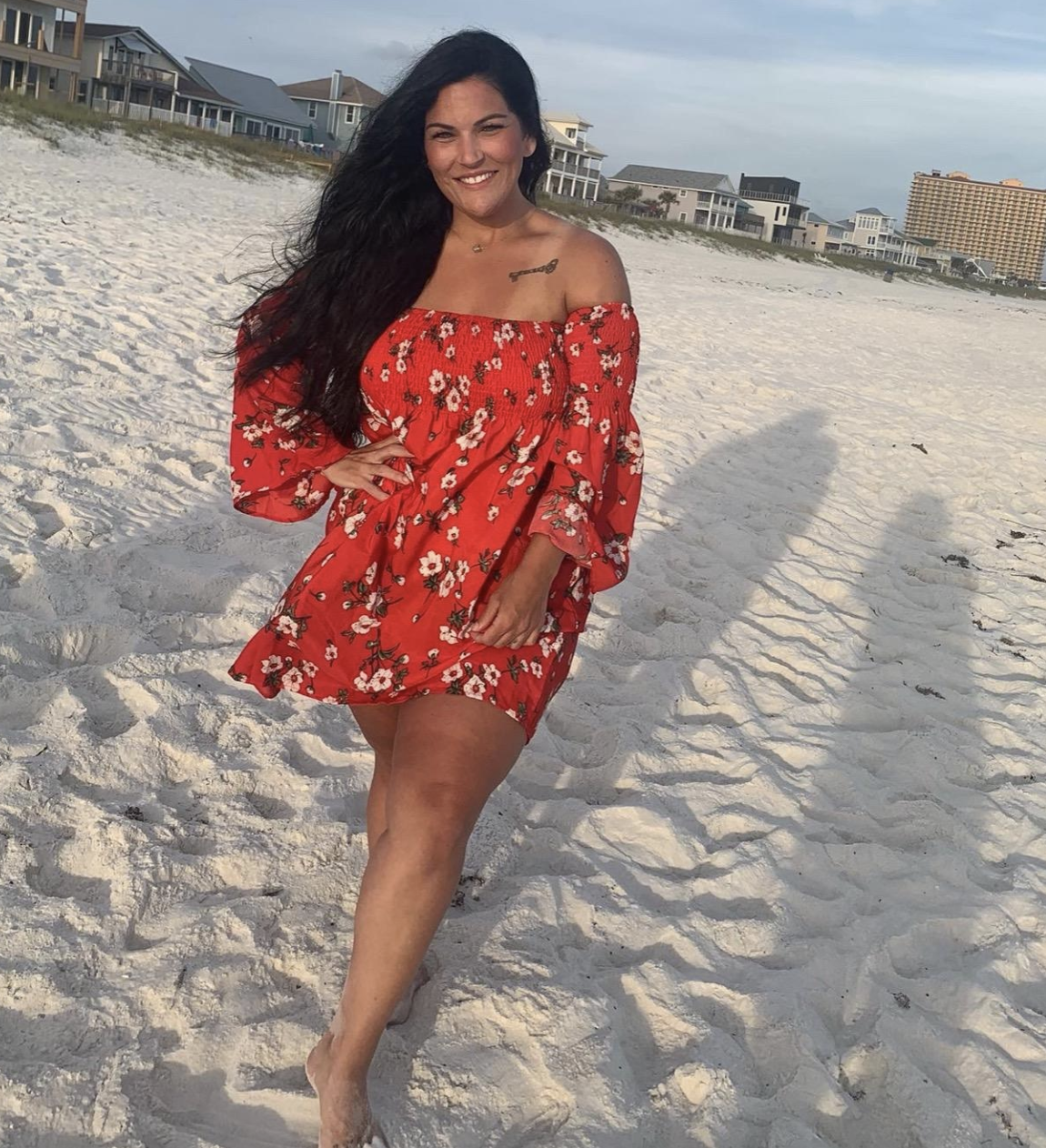 reviewer wearing the red floral off-shoulder dress
