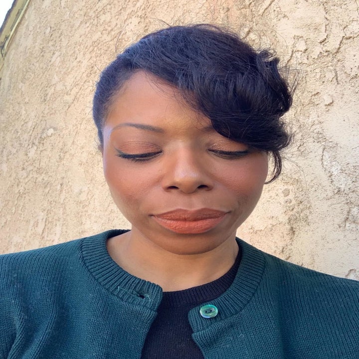 a reviewer with pink lipstick on