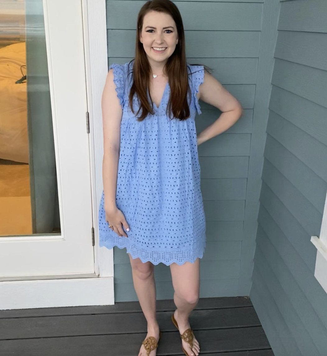 reviewer wearing the blue mini dress