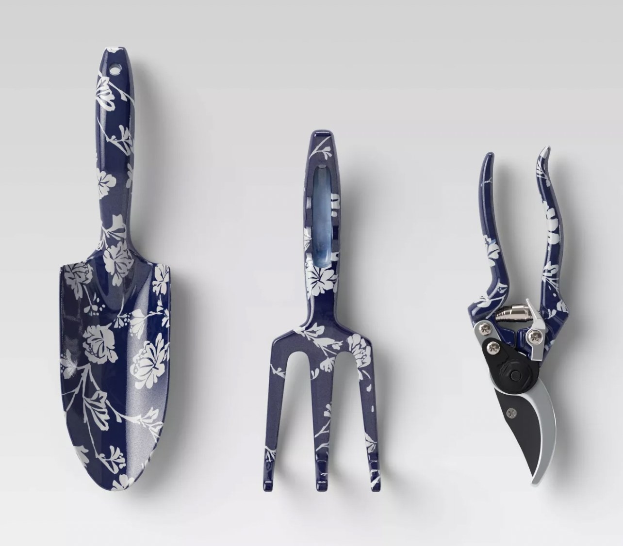 a navy and white garden tool set with a garden trowel, cultivator and secateurs
