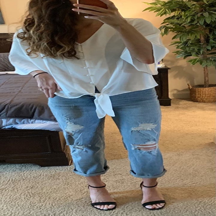 a reviewer wearing the top in white