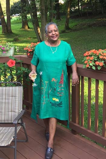 A reviewer wearing the embroidered midi dress in turqoise 