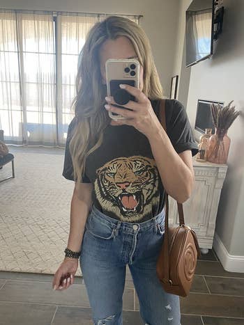 a reviewer wearing the tiger tee in black