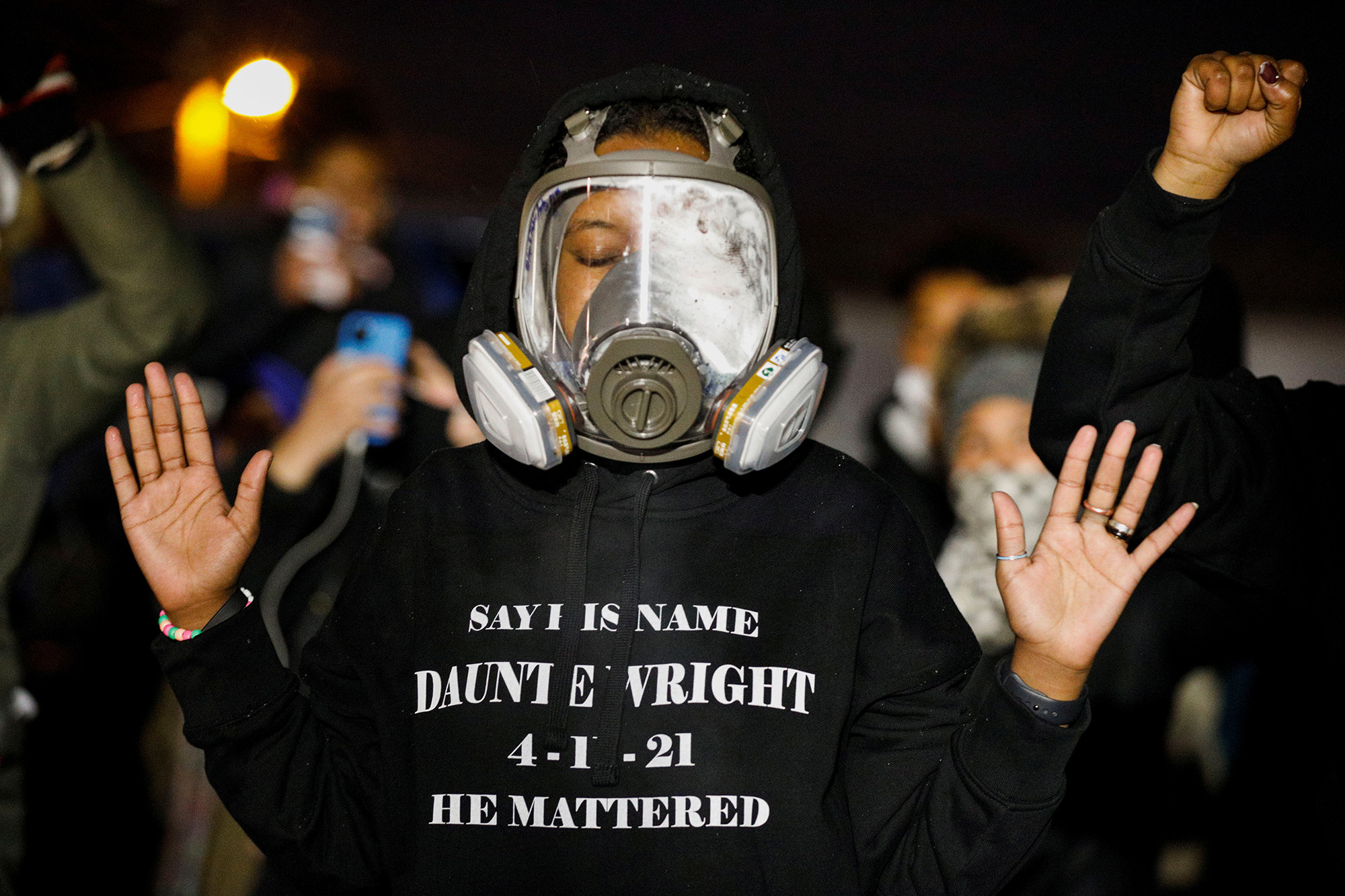 The protester&#x27;s sweatshirt says &quot;Say his name: Daunte Wright. 4-11-21. He mattered.&quot;
