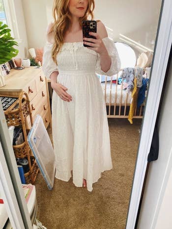 a reviewer mirror selfie of someone wearing the A-line dress in white 
