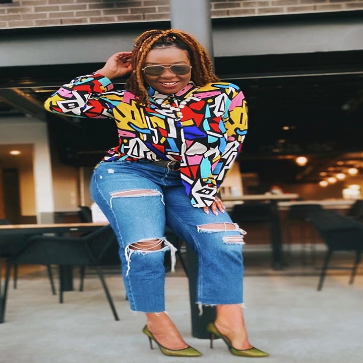 front view of a reviewer wearing the colorful top 