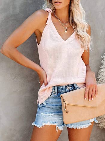 model wearing the top in pink with denim shorts 