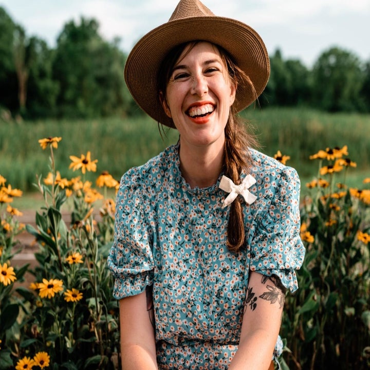 a reviewer wearing the top in green