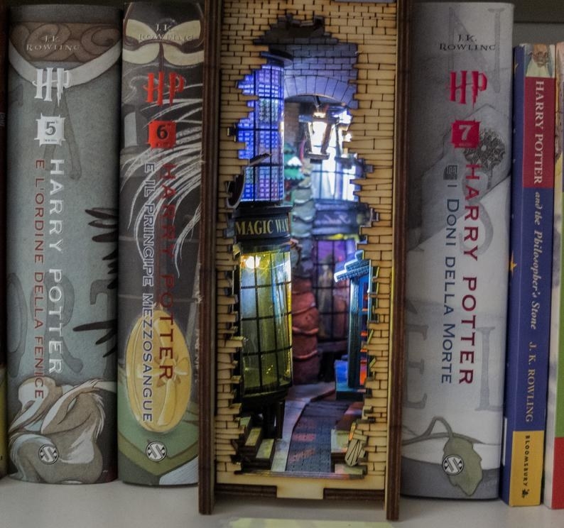 the Wizard&#x27;s Alley-themed bookshelf insert surrounded by Harry Potter books 