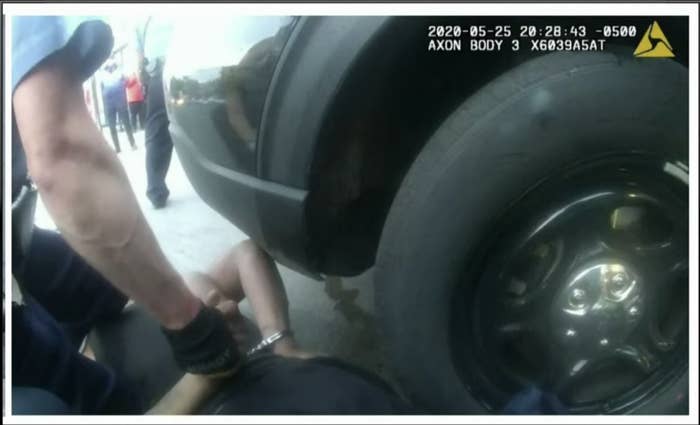 Footage from a police body camera shows Chauvin with his knees on top of Floyd, who is facedown on the ground by a car's tire