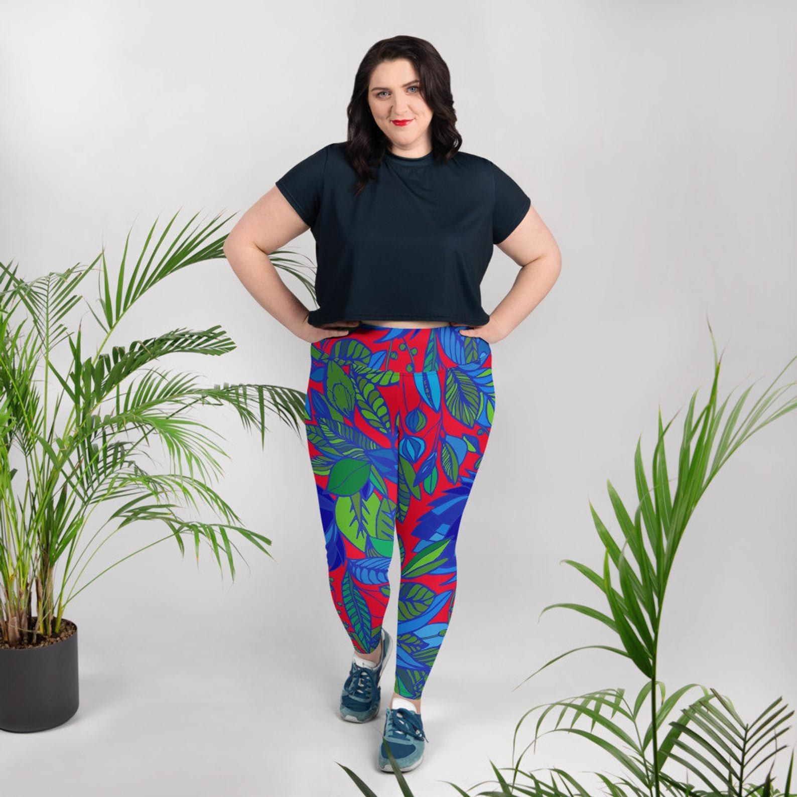 a plus size model wears the red lala plus size leggings with a black crop top