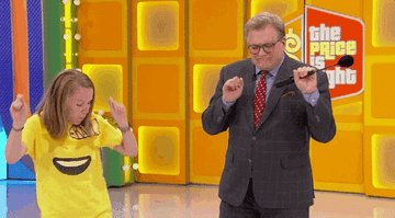 Drew Carey and a the price is right contestant dancing
