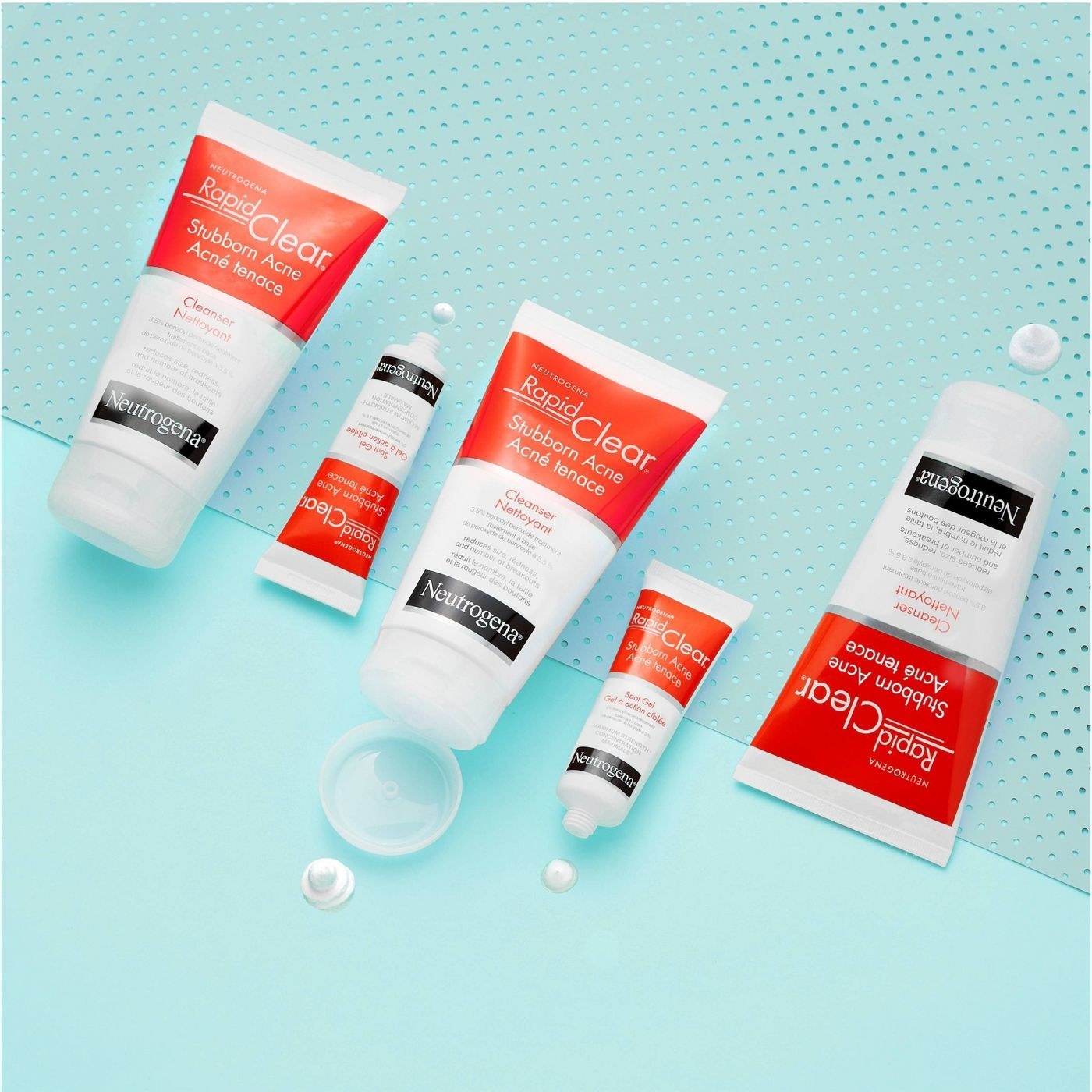 Five bottles in varying sizes of facial acne cleanser