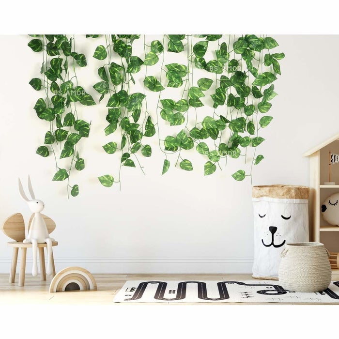 The artificial vines hung up on a wall in a kid's room.