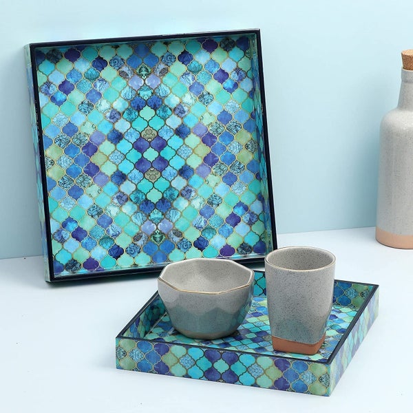 The tray with a bowl and glass on it.