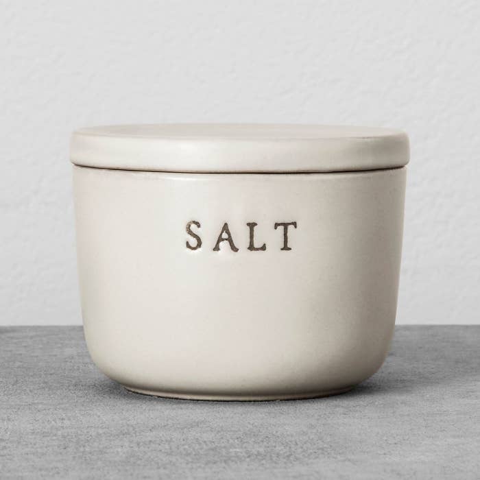 white stone salt cellar with lid and &quot;salt&quot; engraved on the front