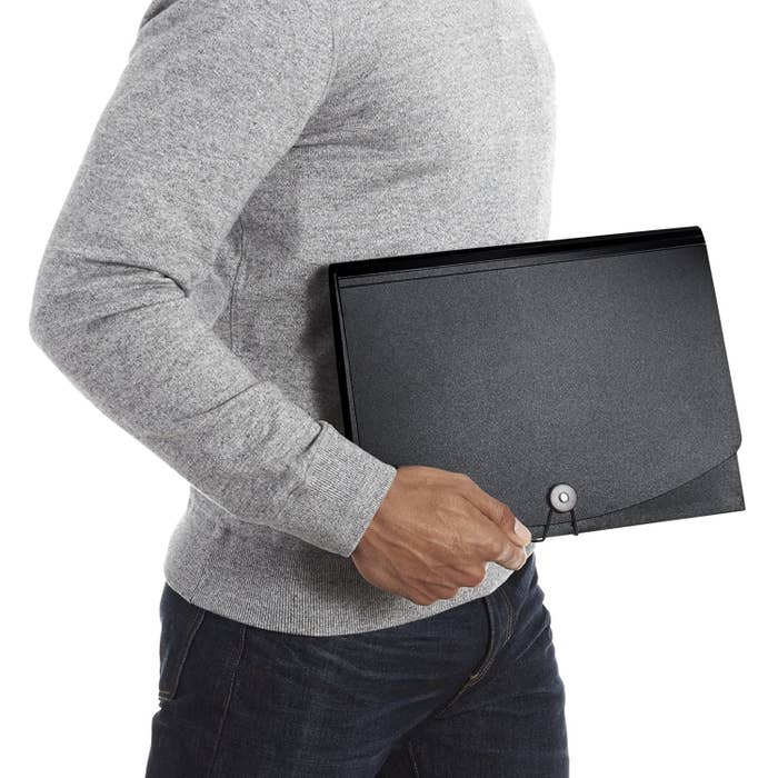 A man holding an expanding folder 