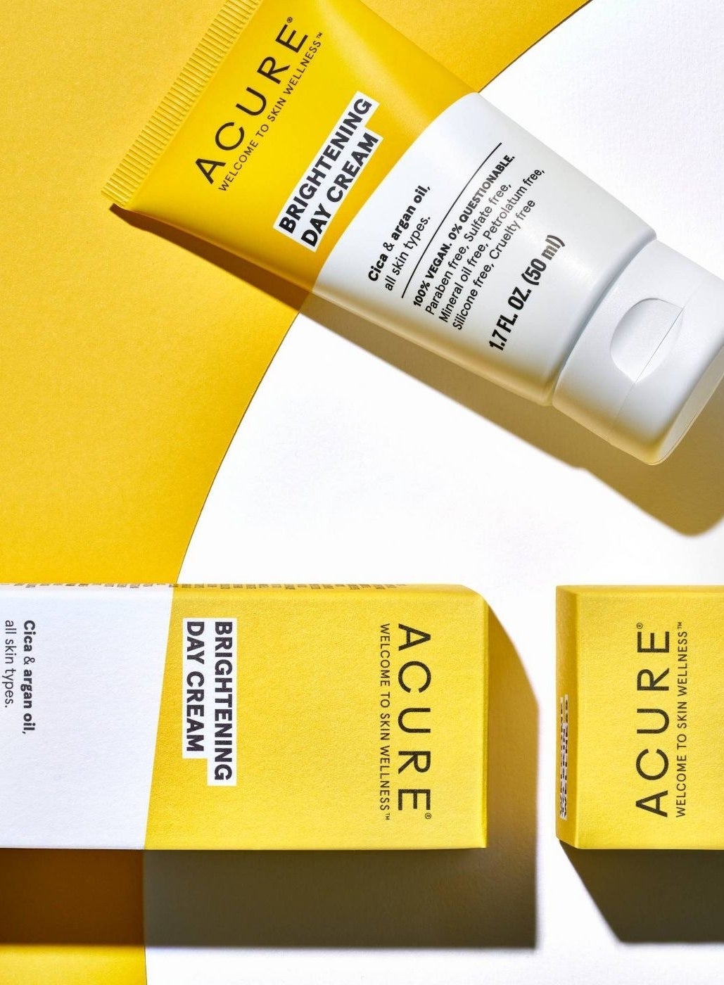 A yellow and white tube of brightening day cream